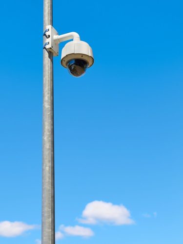 CCTV camera pole installed in a commercial parking lot for 24 7 surveillance