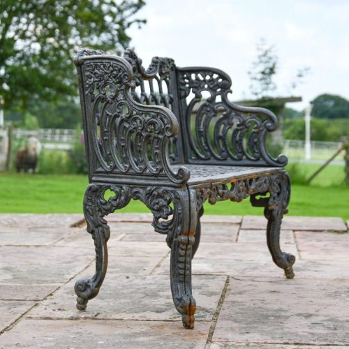 Decorative cast iron bench with floral backrest pattern