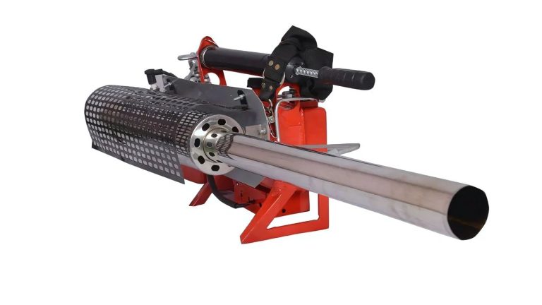 Electric fogging machine spraying disinfectant in a warehouse