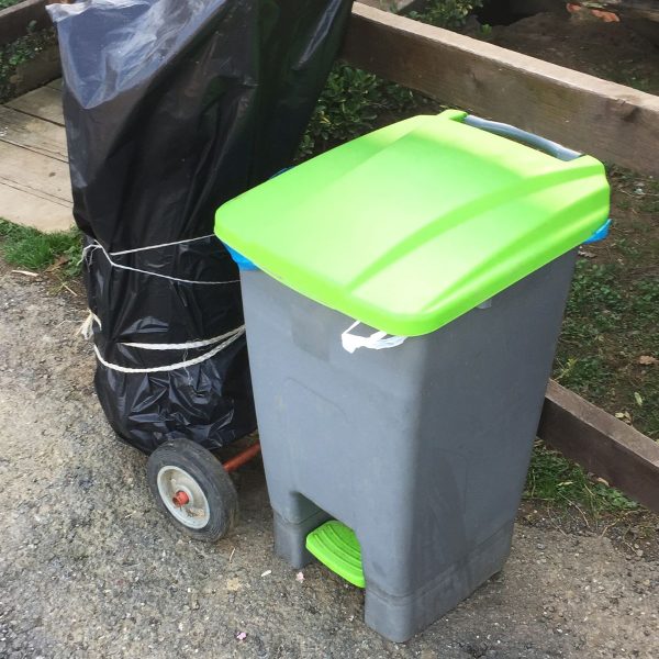 Green plastic dustbin with lid for home and office waste disposal