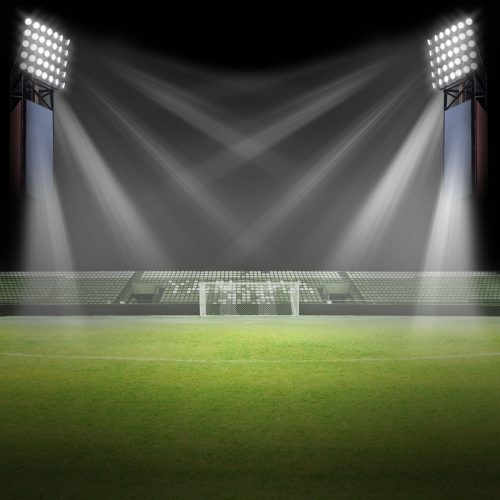High power stadium flood light illuminating a large football field at night