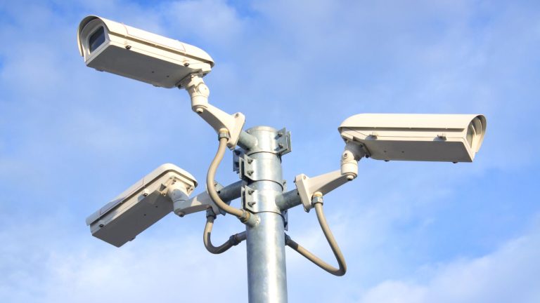 Modern CCTV camera pole setup in a residential neighborhood