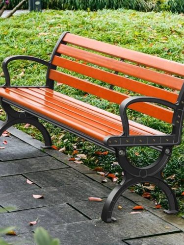 Ornate cast iron park bench with wooden slats