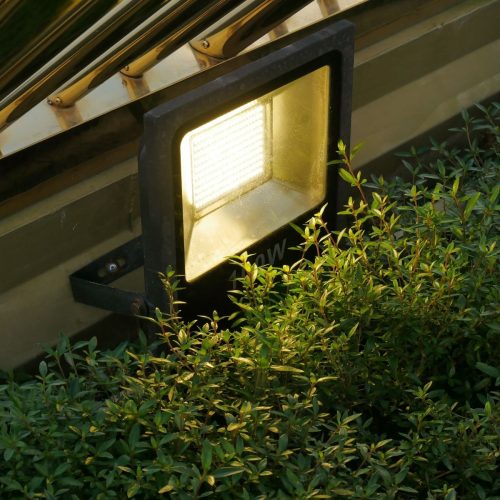 Post top lights illuminating a residential garden path at night