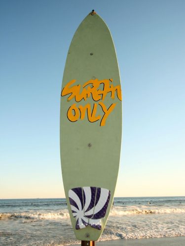 Professional surfer riding waves with eco friendly surf board