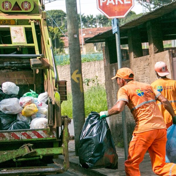 Rear loading garbage truck disposing waste at landfill