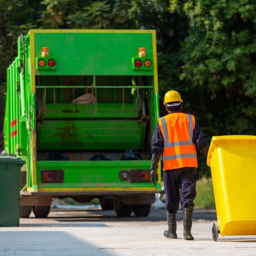 Solar powered garbage truck with green energy branding