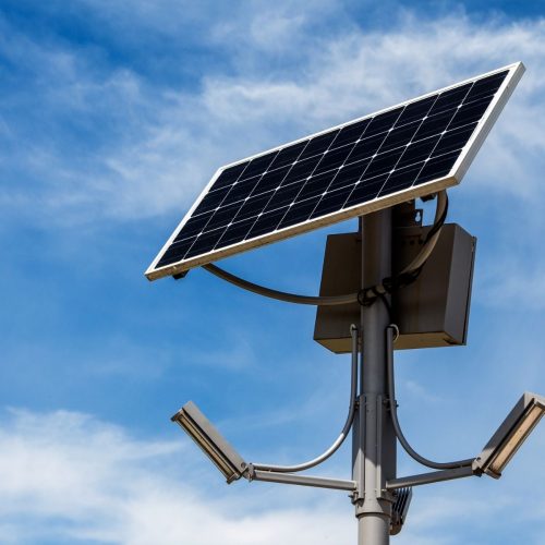 Solar street light with lithium battery and motion sensor in a parking lot