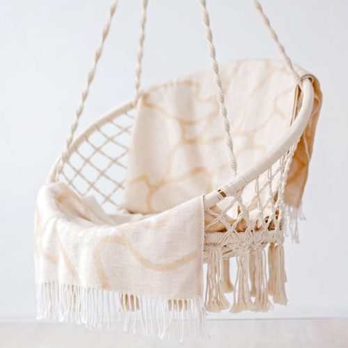 Stylish patio swing chair with canopy in a backyard setting
