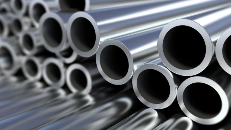 Technicians inspecting steel tubes and pipes at Trivenisolar plant