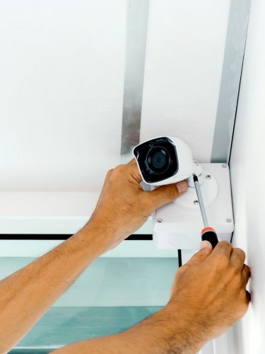 Weatherproof CCTV camera mounted outside a commercial building